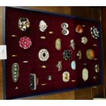 Thirty-five dress rings in display case