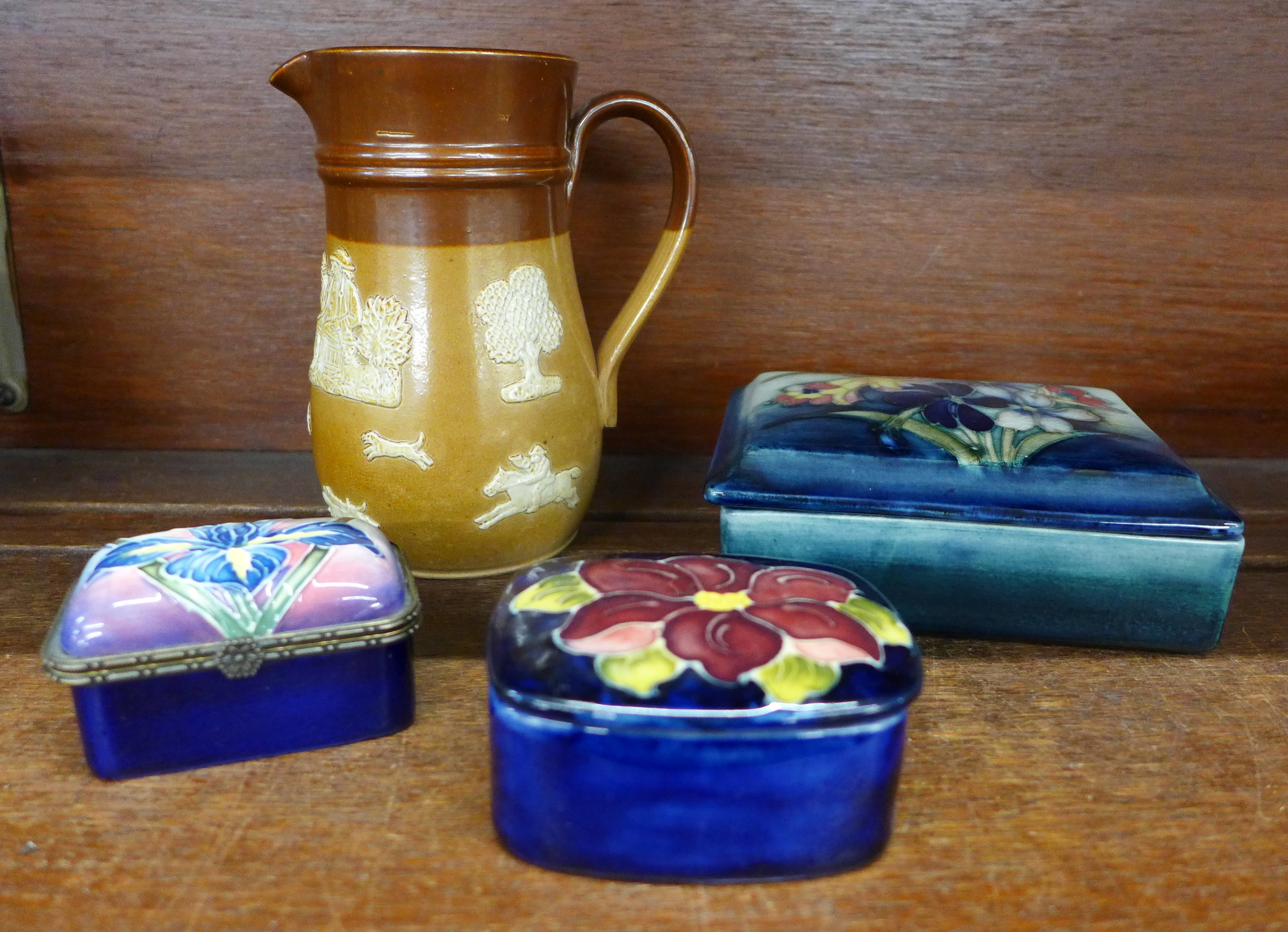 Two Moorcroft pots, the larger one signed W.Moorcroft, an Old Tupton ware pot, and a Royal Doulton