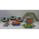 Six Hornby 0 gauge pre-war wagons, a tinplate footbridge and a buffer stop