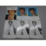 Roger Moore: six small publicity photos, posed as James Bond, The Saint and one other, all signed