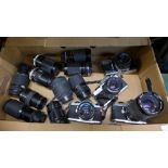 Four vintage SLR cameras and ten lenses