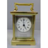 A silver fronted brass carriage clock with purchaser's receipt, boxed