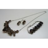 A silver gem set necklace, bracelet and earrings