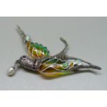 A silver and plique a jour bird brooch with ruby collar, 9.6g