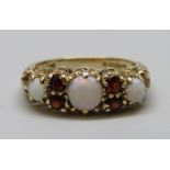 An antique style 9ct gold, opal and garnet ring, 2.7g, K