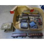A box of tin plate O gauge model rail including rolling stock, a bridge and two locomotives, etc.