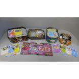 A collection of Pokemon cards in two tins