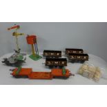 Six 0 gauge Hornby wagons including a well wagon and a crane wagon with a tinplate signal and a