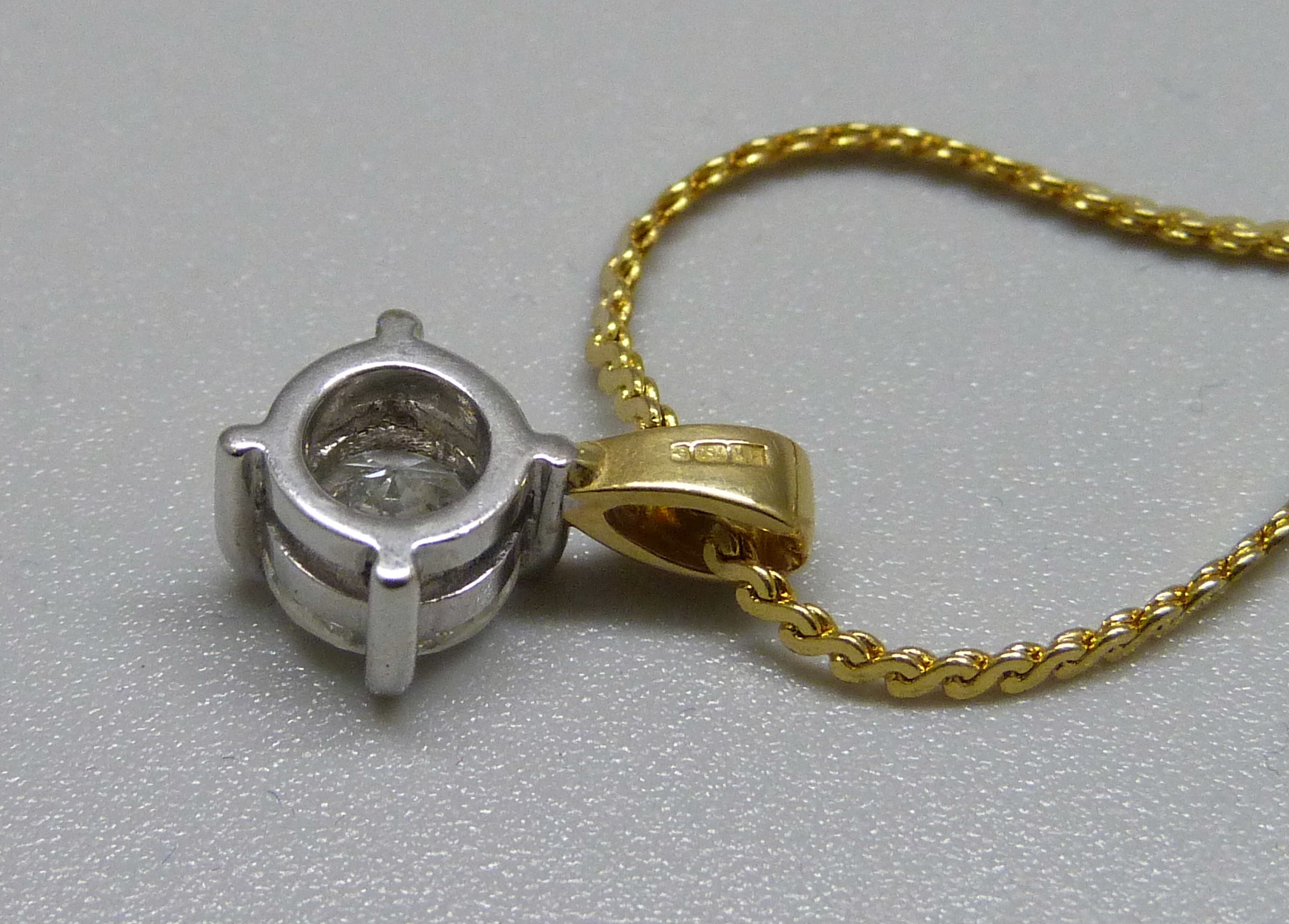 An 18ct gold and diamond pendant, approximately 0.90ct diamond weight, on a plated chain - Image 2 of 3