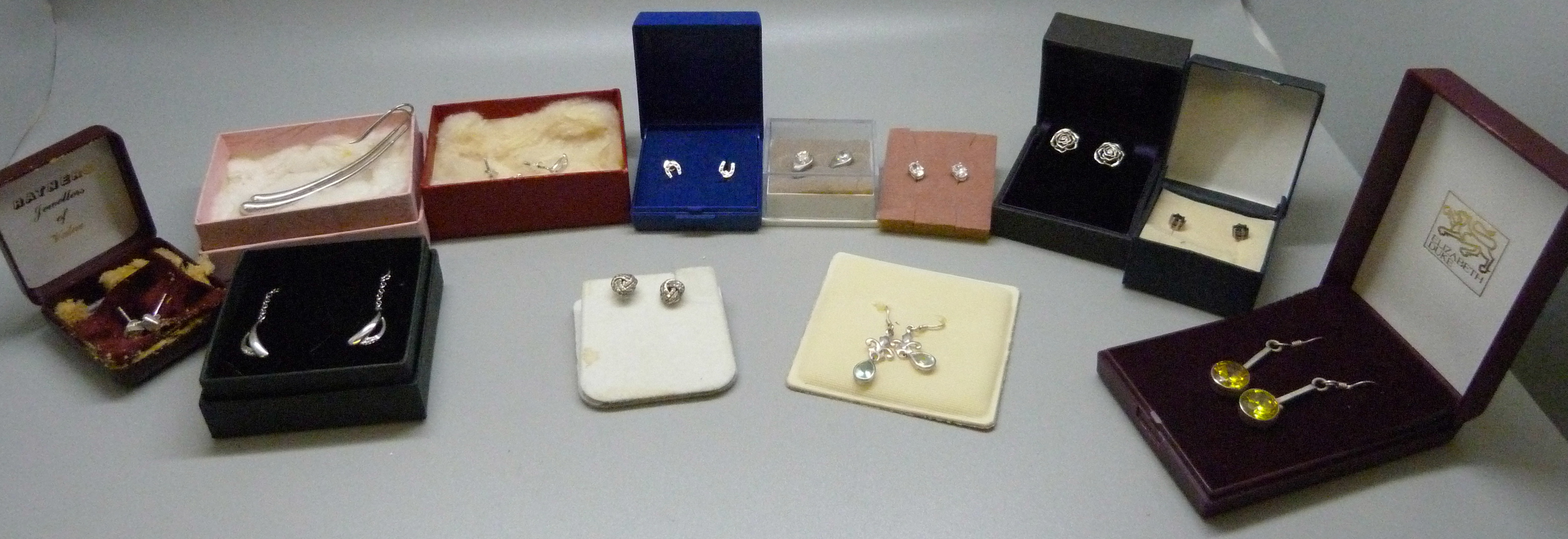 Twelve pairs of silver earrings