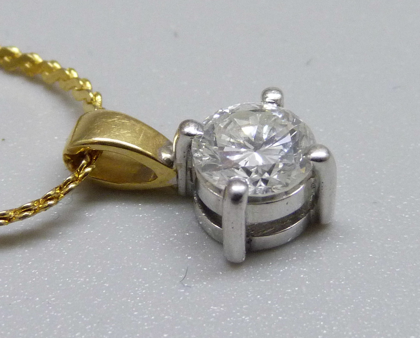 An 18ct gold and diamond pendant, approximately 0.90ct diamond weight, on a plated chain - Image 3 of 3