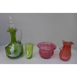 A group of coloured glass to include a green Mary Gregory claret decanter with similar beaker with