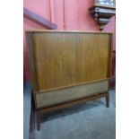 A Danish teak tambour front cabinet