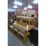 A teak extending table and six chairs