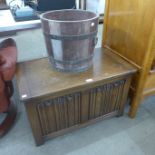 An oak linenfold panel blanket box and a brass banded log box