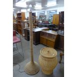 A wicker laundry basket and a floor standing lamp