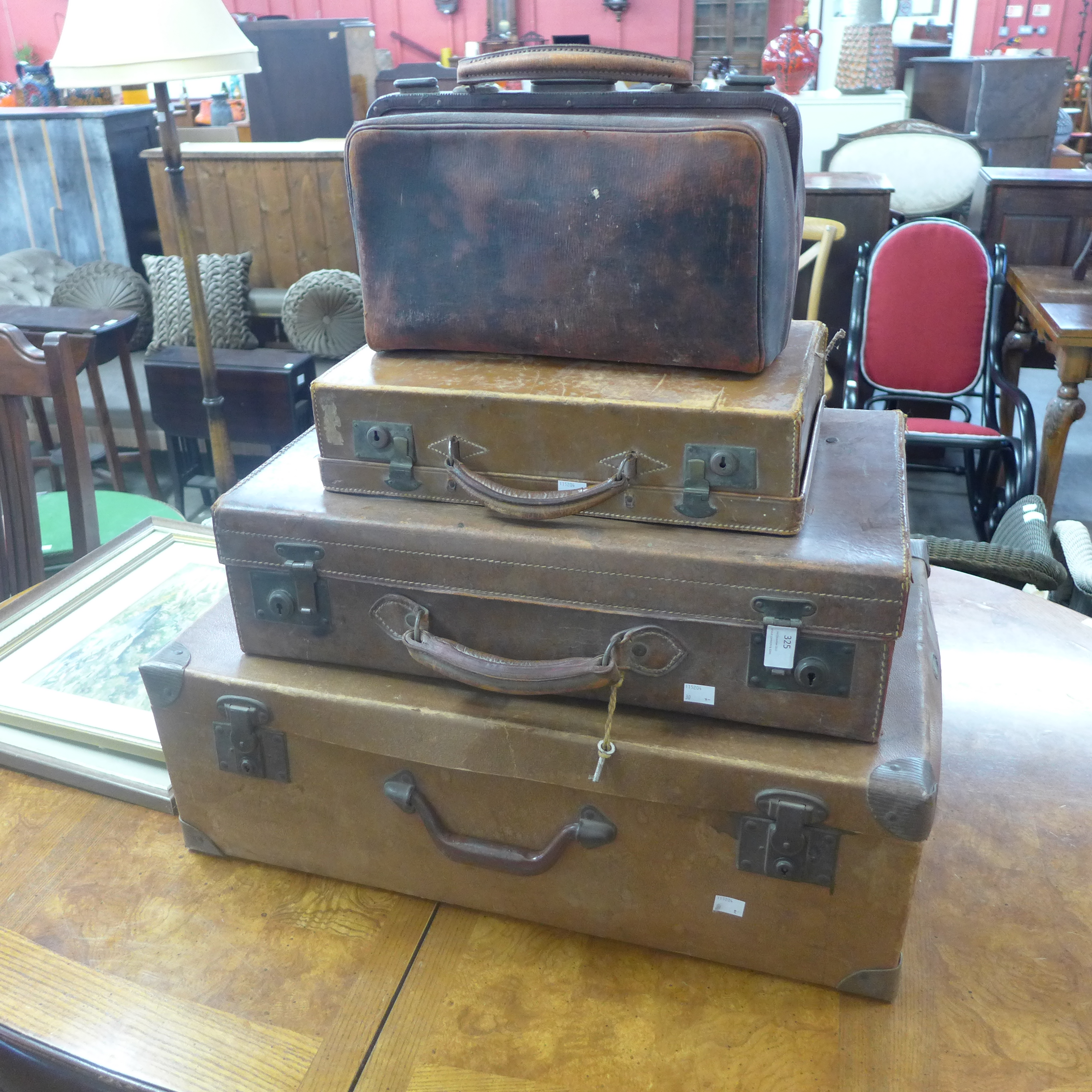 Three vintage suitcases and a doctor's bag
