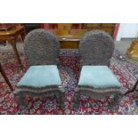 A pair of Anglo Indian carved padouk wood chairs