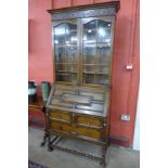 An early 20th Century oak barleytwist bureau bookcase