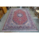 A Persian red ground Kashan rug, 382 x 285cms