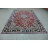 A Persian red ground Isfahan rug, 350 x 243cms