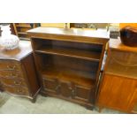 A carved oak open bookcase