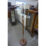 A teak floor standing lamp