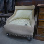 A Victorian ebonised and fabric upholstered nursing chair