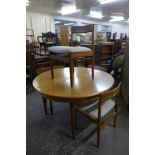 A teak extending dining table and four chairs