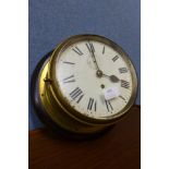 An early 20th Century brass cased circular ship's clock