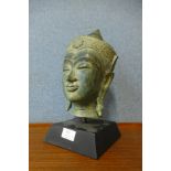 An eastern bronze effect bust of a deity