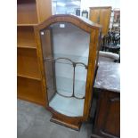 An Art Deco walnut single door display cabinet