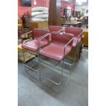 A set of four chrome and red vinyl bar stools