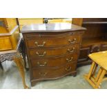 A mahogany serpentine chest of drawers, with brushing slide