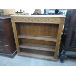 A carved oak open bookcase