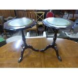 A pair of mahogany and green leather topped tripod wine tables