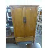A Chinese softwood two door wardrobe
