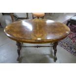 A Victorian carved inlaid burr walnut oval stretcher table