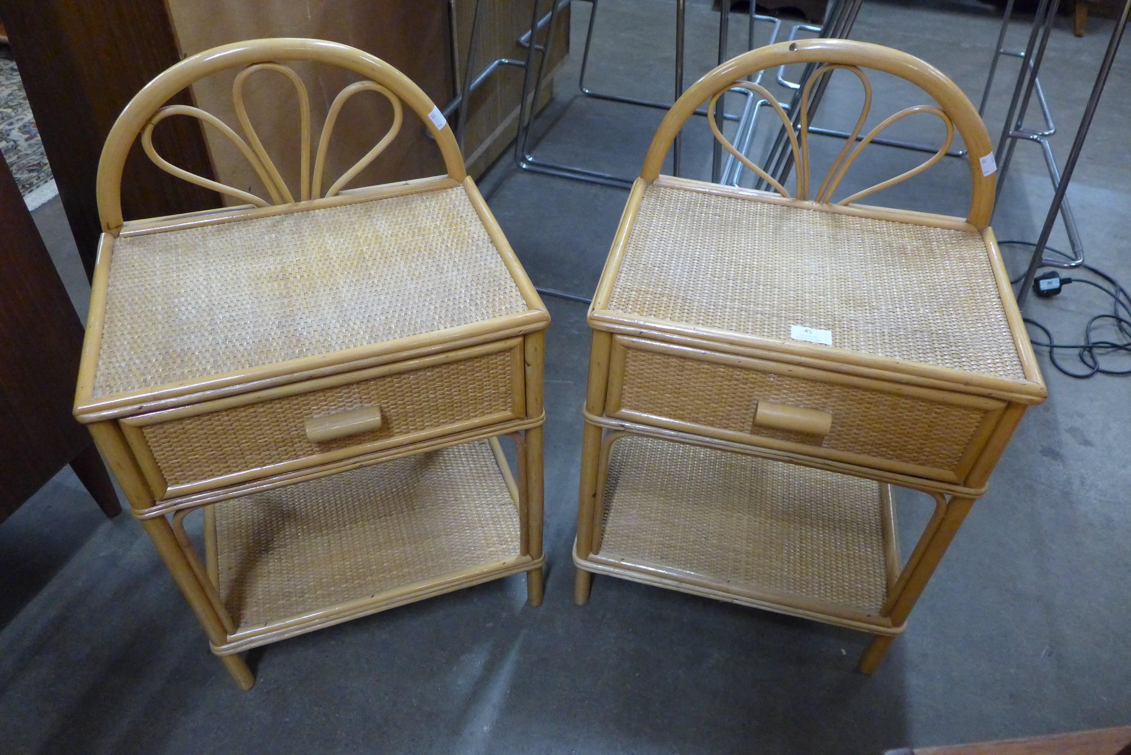 A pair of bamboo and rattan bedside tables