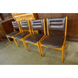 A set of four beech and brown vinyl dining chairs