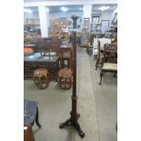 An Arts and Crafts oak floor standing lamp