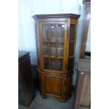 An oak and elm freestanding corner cabinet