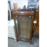 A walnut bow front display cabinet