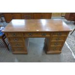 A late Victorian walnut kneehole desk