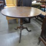 A George III oak circular tripod tea table