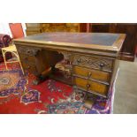 A 17th Century style carved Ipswich oak and green leather topped desk