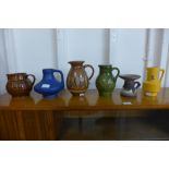 A West German 282-15 Schlossberg glazed pottery jug and five other glazed jugs, etc.