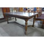 A 17th Century style carved oak extending refectory table