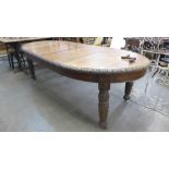 A Victorian oak extending dining table