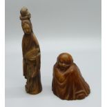 A carved horn figure of a seated elder and a carved horn figure of a Japanese Geisha